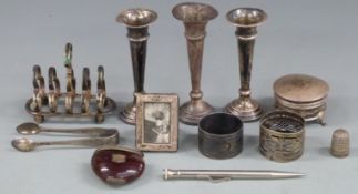 Three hallmarked silver trumpet vases, height 11.5cm, George V hallmarked silver dressing table