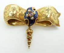 Victorian gold bow brooch with engraved scrolling detail set with a central foiled quartz surrounded