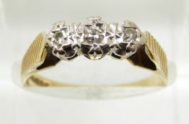 An 18ct gold ring set with three diamonds in a platinum setting, 3.1g, size M