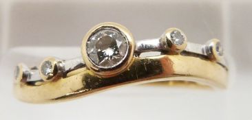 An 18ct bi-coloured gold ring set with five diamonds, 2.1g, size L