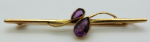 A Victorian pendant set with a large round cut amethyst surrounded by diamonds on a 9ct gold bow