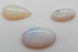 Two oval opal cabochons approx 2ct & 0.7ct and a pear cut cabochon approximately 1.5ct