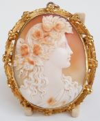 Victorian cameo pendant depicting a lady with flowers in her hair within a foliate border, 6cm long