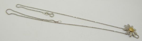 An 18ct white gold daisy pendant and a 9ct white gold chain, 3.5g