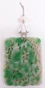 A large pierced Chinese jadeite plaque with a white metal pendant fitting set with a pearl, 5.5cm