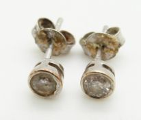 A pair of 9ct white gold earrings each set with approximately 0.15ct