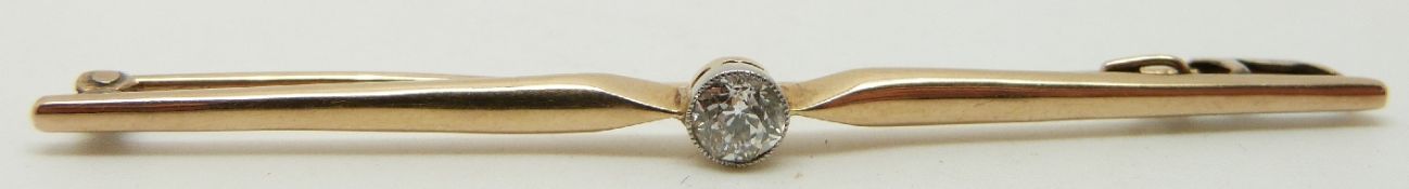 A 9ct gold bar brooch set with an old cut diamond measuring approximately 0.2ct