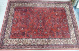 Red ground wool rug with beige border, 170 x 237cm