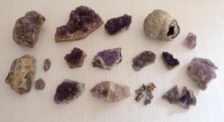 A collection of amethyst quartz part geodes and other mineral samples.