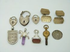 A pair of silver cufflinks, three silver padlocks, silver England pendant, silver pendant, watch key