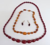 Two amber necklaces, one cherry amber of 47 graduated oval beads the largest 25x17.5mm, 46g with