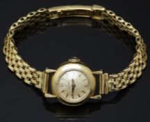Omega 18ct gold ladies wristwatch ref. 10774 with gold hands and hour markers, champagne dial and
