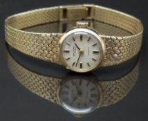 Waltham 9ct gold ladies wristwatch with black hands, two-tone baton markers, silver dial and 17