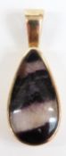 A 9ct gold pendant set with a pear cut fluorite cabochon, 4g