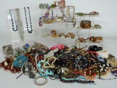A collection of costume jewellery including white metal brooch set with enamel, silver bangle,