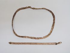 A tri-coloured 9ct gold necklace, 21cm drop, and a similar bracelet, weight of both 13.7g