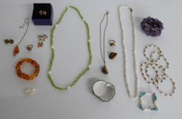 A collection of silver jewellery including rings, earrings set with pressed amber, amethyst