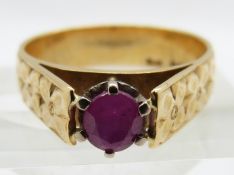 An 18ct gold ring set with an oval cut ruby, 4.8g, size M