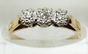 An 18ct gold ring set with three diamonds in a platinum setting, 2.2g, size K