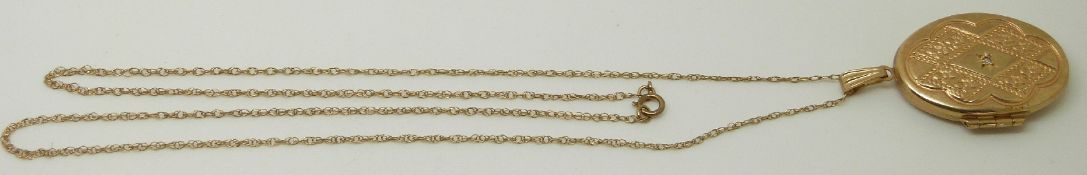 A 9ct gold locket set with a diamond on 9ct gold chain, 4.1g
