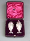Cased pair of George V hallmarked silver peppers, Birmingham 1905 maker William Henry Sparrow,