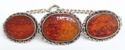 A silver bracelet set with Carnelian agate carved with script detail