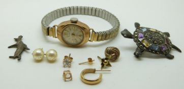 A 9ct gold ladies watch, a pair of silver earrings, a penguin charm and a silver turtle brooch