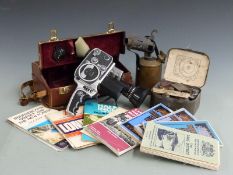 A collection of maps, blowtorch, Bolex cine camera etc