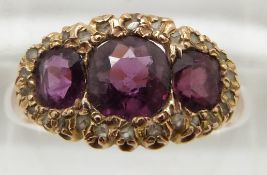 Victorian 15ct gold ring, Birmingham 1899, set with cushion cut garnets surrounded by diamonds,