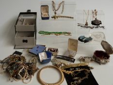 A collection of costume jewellery including brooches, garnet necklace, Avon, etc