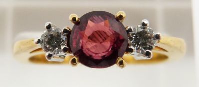 An 18ct gold ring set with a round cut natural ruby of approximately 0.7ct, origin Sri Lanka, and
