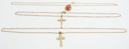 A 9ct gold pendant set with a coral cabochon and two 9ct gold crosses and chains, 6.6g