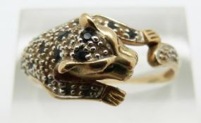 A 9ct gold ring in the form of a leopard set with sapphires and diamonds, 3.3g, size U