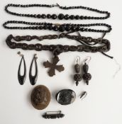 A vulcanite necklace, two French jet necklaces, a vulcanite cameo brooch, carved jet brooch etc