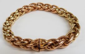 An 18ct gold plaited bracelet made up of rose and yellow gold sections, 33.7g