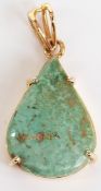 A yellow metal pendant set with a pear cut azurite cabochon