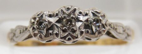 An 18ct gold ring set with three diamonds in a platinum setting, 3.1g, size M