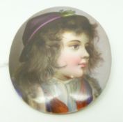 A porcelain brooch painted with a portrait miniature, 5 x 6cm