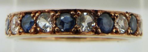 A 9ct gold eternity ring set with alternating sapphires and white sapphires, 4.1g, size N