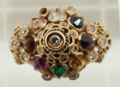 A 18k gold ring set with diamonds, a pink sapphire, emerald, tiger's eye, garnet, citrine, topaz