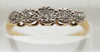 An 18ct gold ring set with five diamonds in a platinum setting, 1.7g, size L