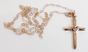 A 9ct gold cross pendant set with a pink sapphire, 1.7g
