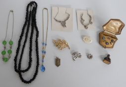 Trifari brooch, glass black beads, a fob, a stud set in original box, paste necklace, mother of
