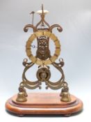 Brass single fusee skeleton clock, passing strike on a bell, raised on an oval mahogany plinth