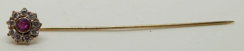 A 9ct gold stick pin set with a ruby and cubic zirconia