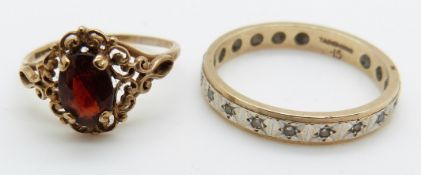 A 9ct gold ring set with a garnet and a 9ct gold eternity ring, 3.9g
