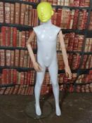 Haberdashery/shopfitting modern articulated child mannequin supported by a removable steel column to