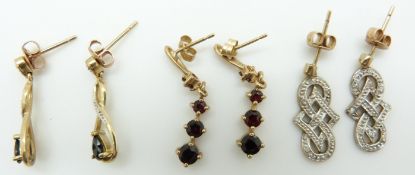Three pairs of 9ct gold earrings comprising one pair set with diamonds, a sapphire pair and a garnet