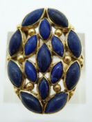 Eastern yellow metal ring set with marquise cut lapis lazuli cabochons, tested as 15ct/16ct gold,