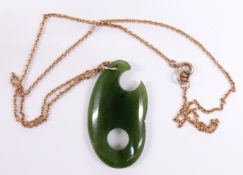 A nephrite jade pendant on 9ct gold chain, 4cm long